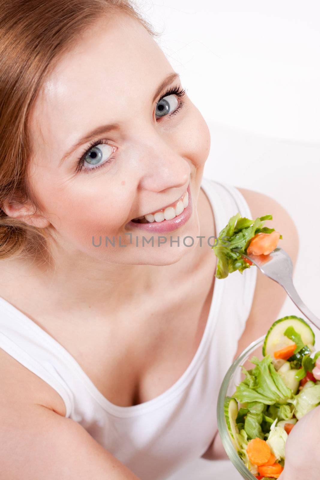 attractive young woman eating fresh healthy salad for lunch
