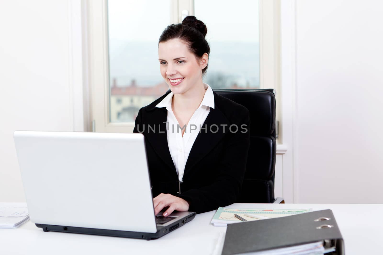 young successful business woman working on computer in office