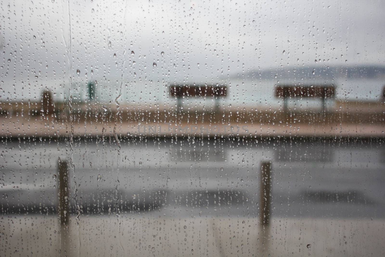 Rain drops on a glass window with a lot of rain outside 