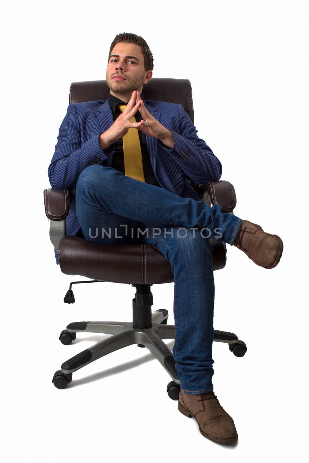 Young businessman sitting on a chair by dwaschnig_photo