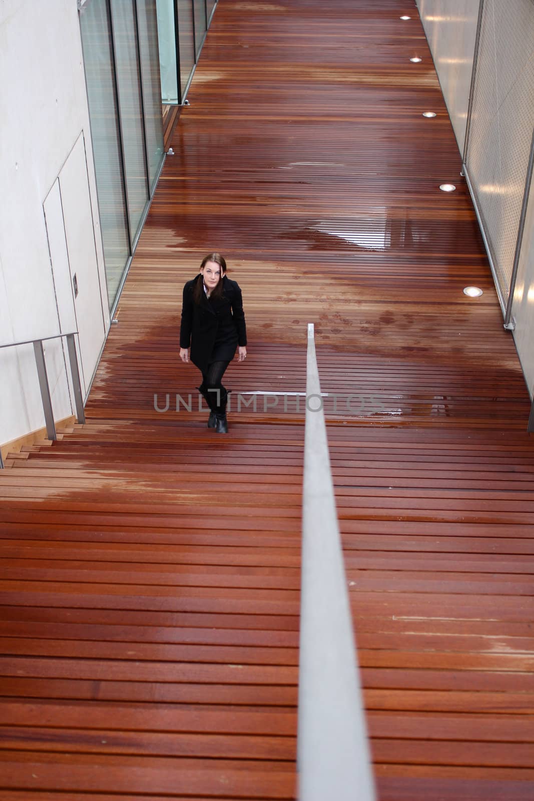 Brunette Woman Walking Up Stairs by dwaschnig_photo