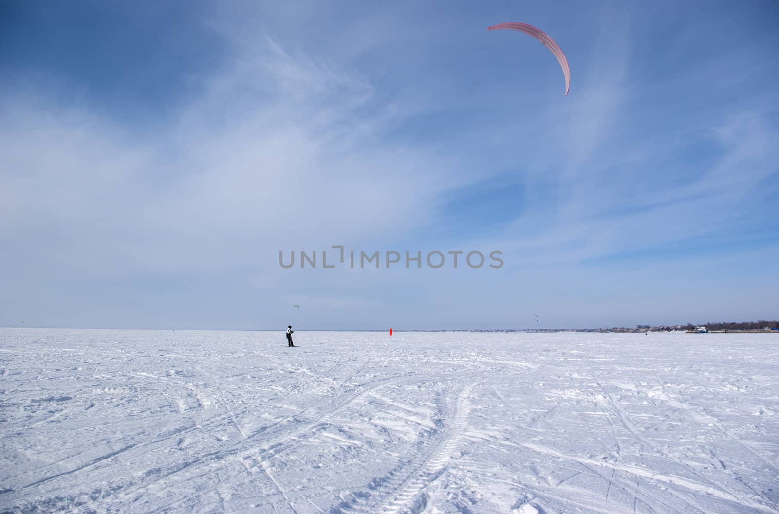 Winter kite skiing on the frozen river