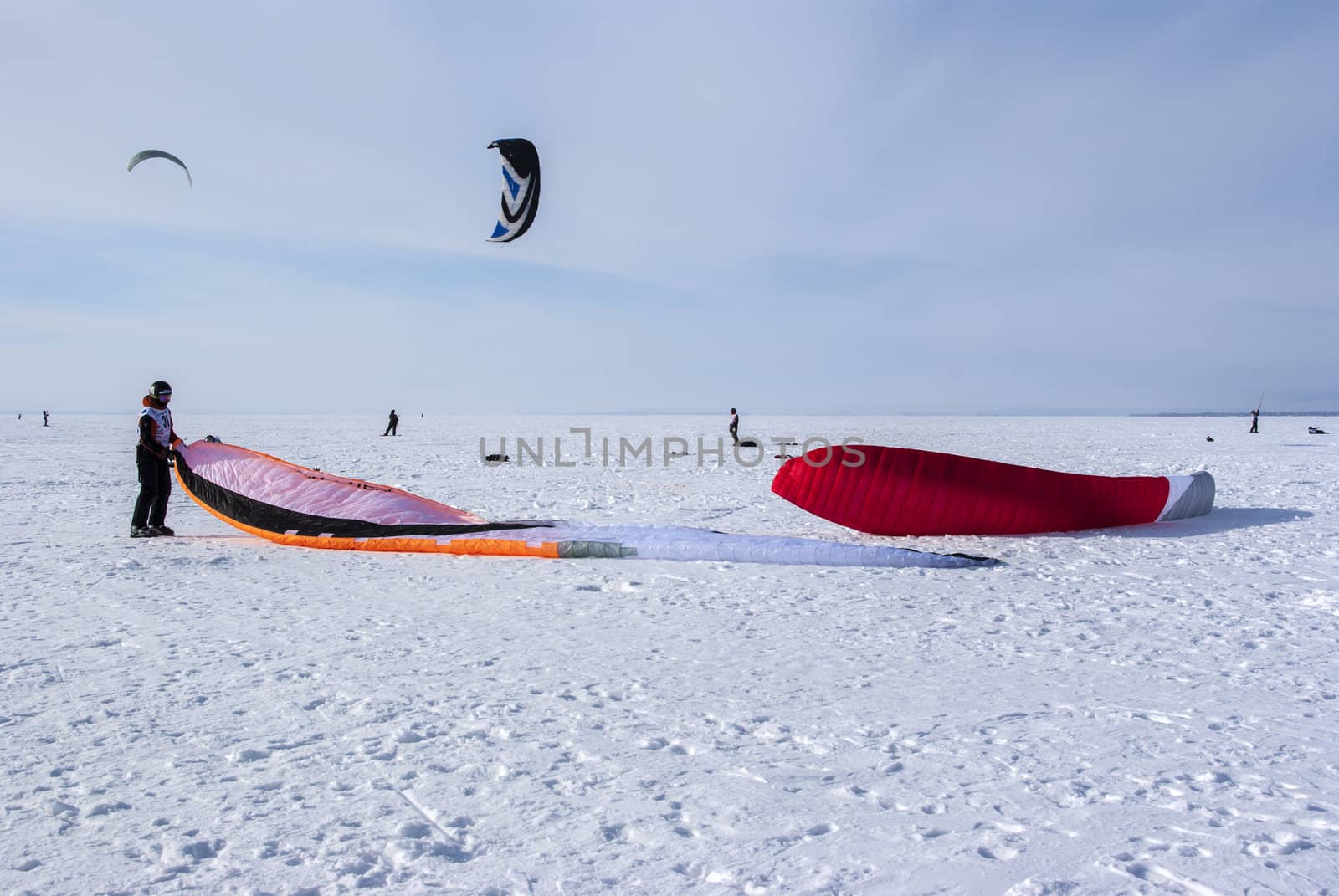 Winter kite skiing on the frozen river