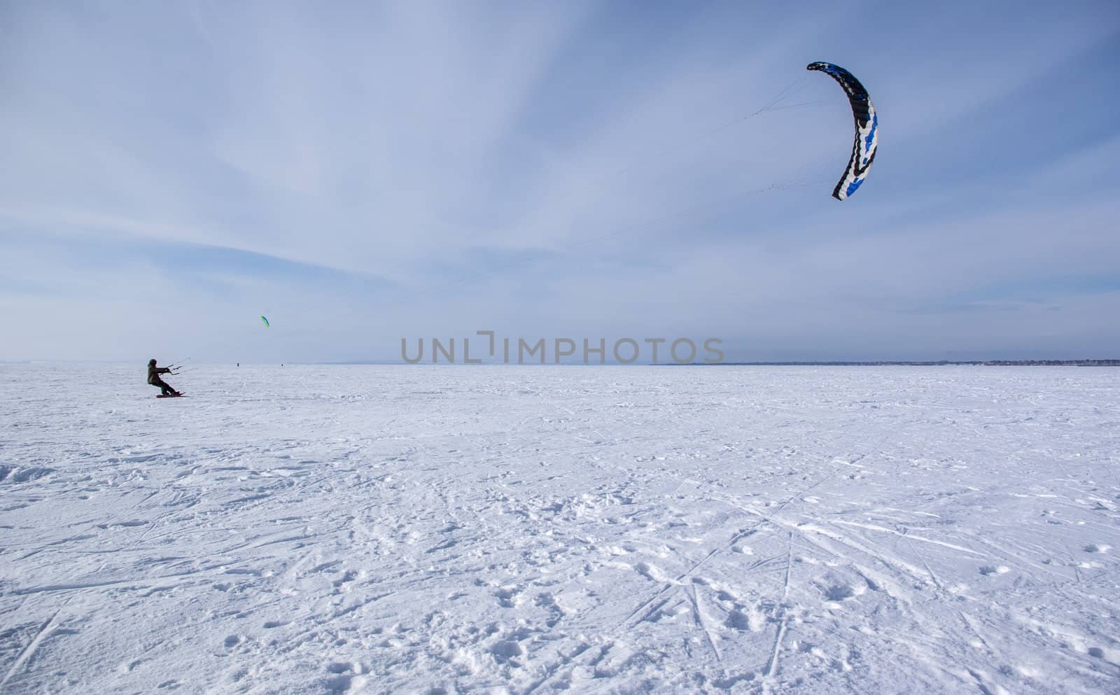 Winter kite skiing on the frozen river