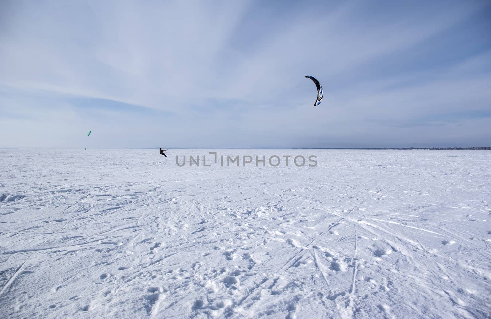 Winter kite skiing on the frozen river