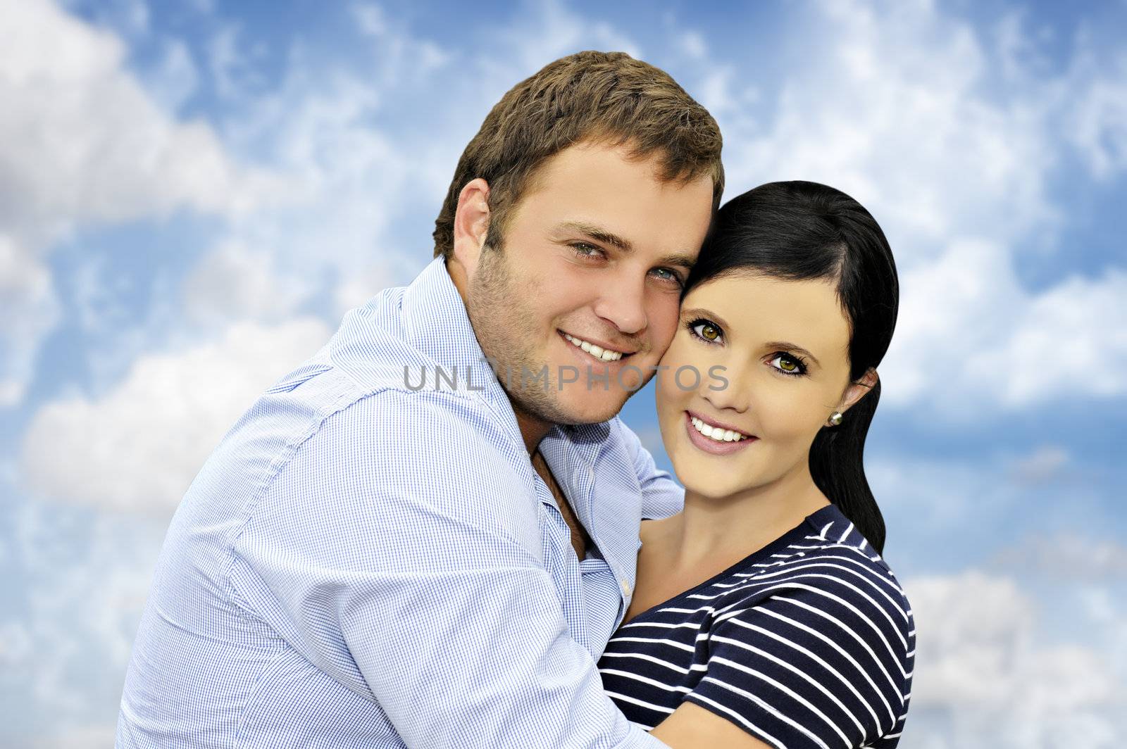 Beautiful happy  young couple with cloud background by tish1