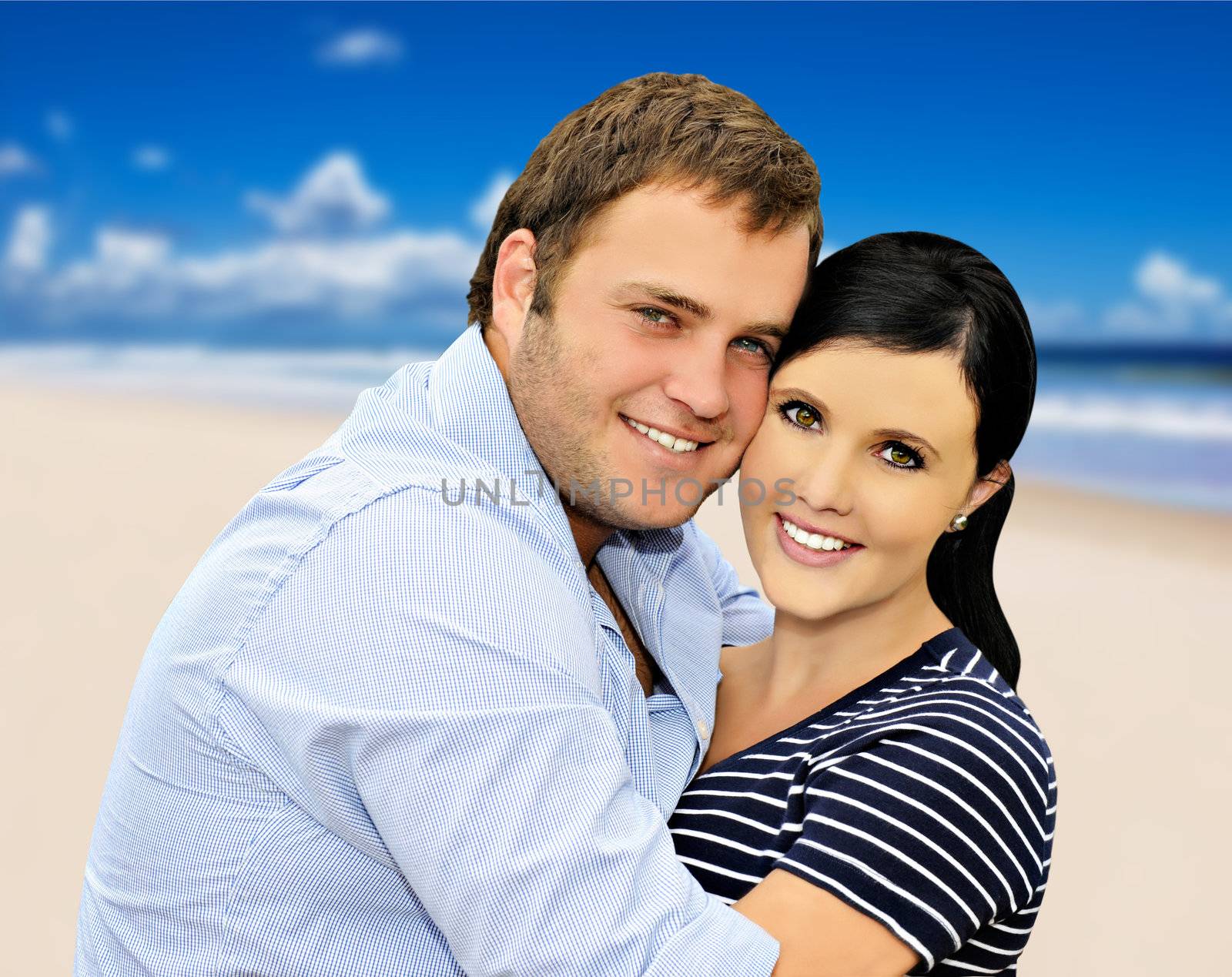 Beautiful young couple with sea and beach in the background