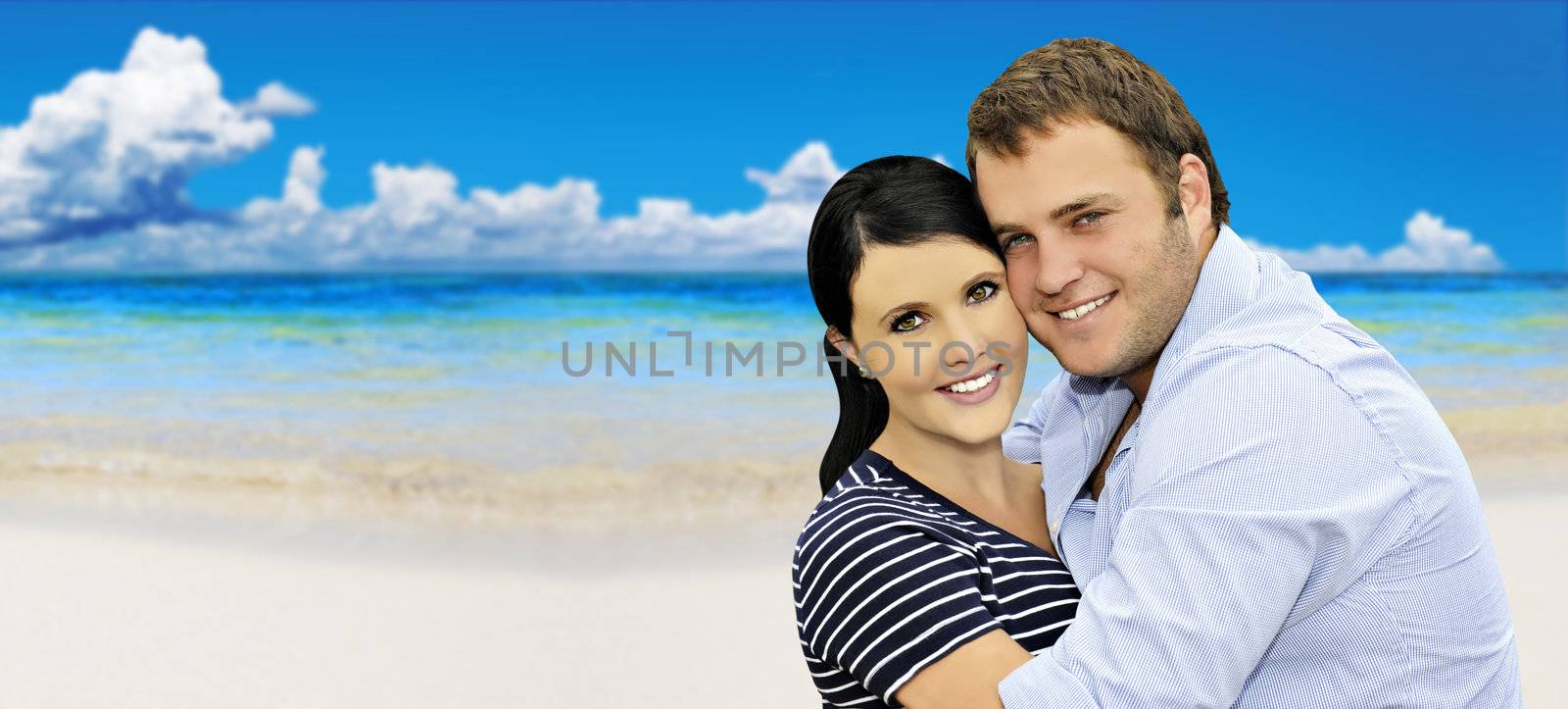 Beautiful happy young couple with sea in the background