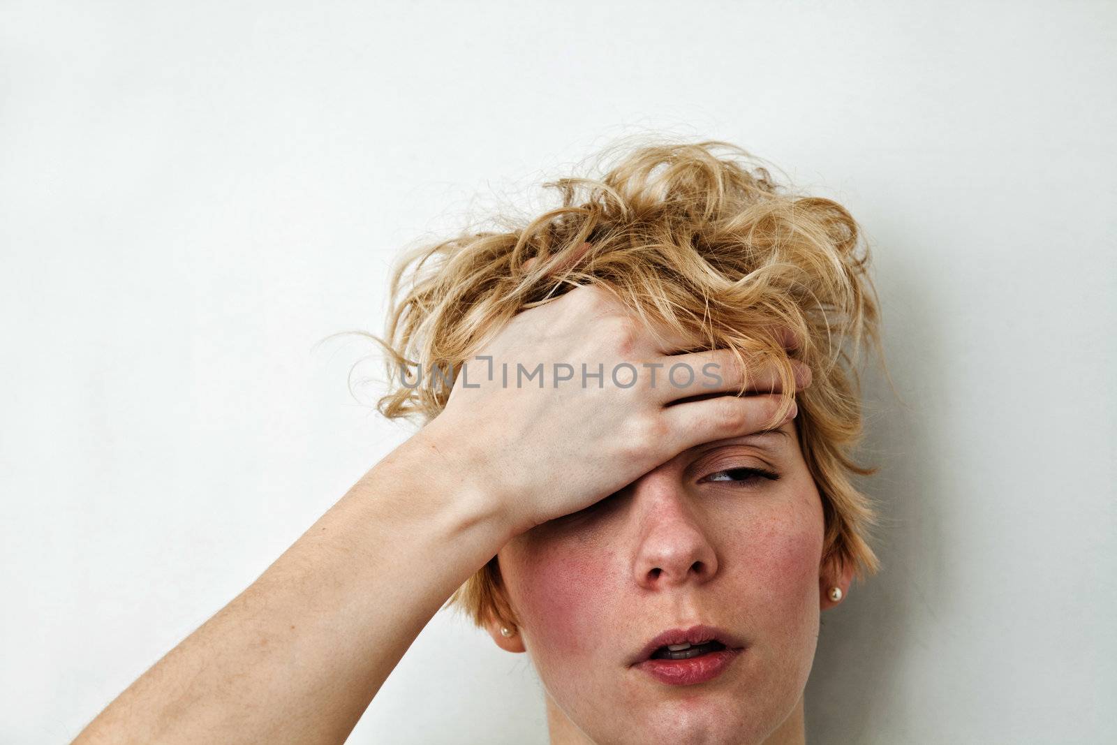 Young blond girl with morning look and mixed hairs on a white background