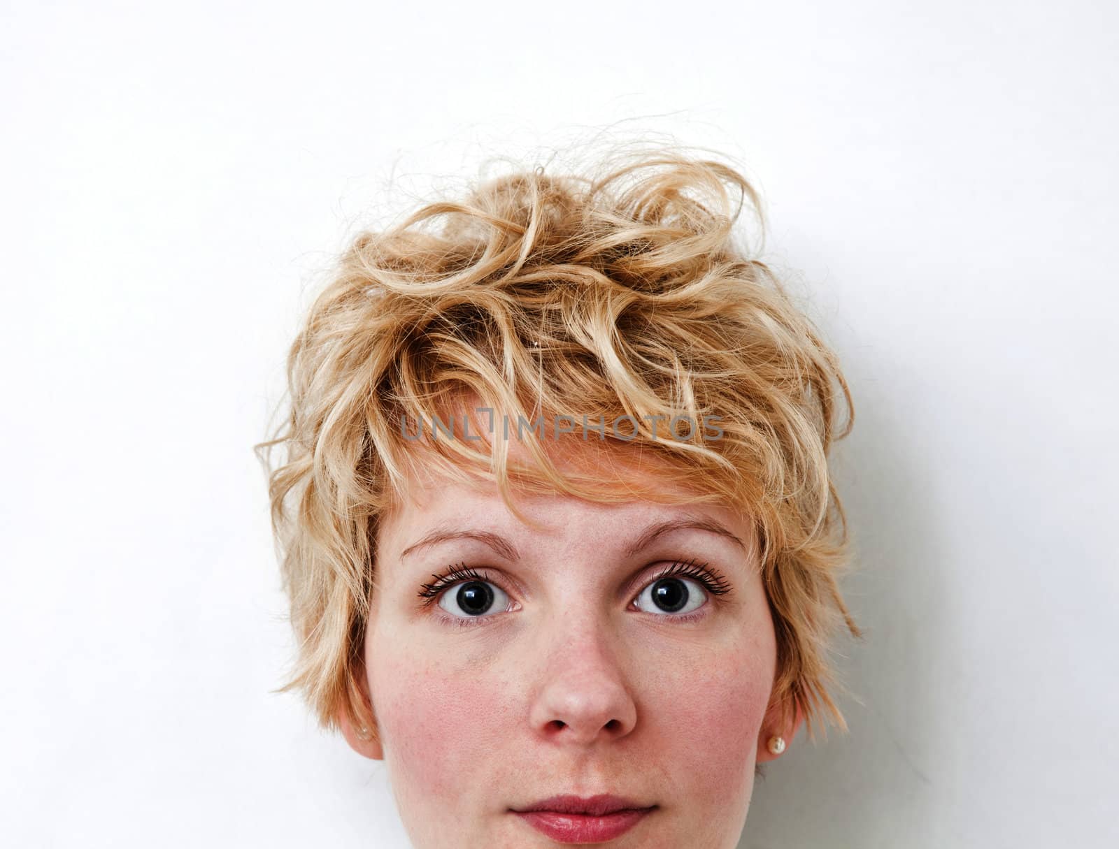 Young blond girl with morning look and mixed hairs on a white background