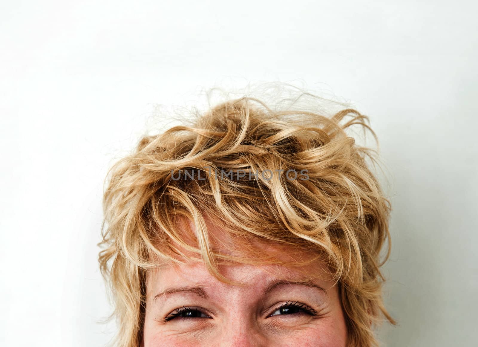 Young blond girl with morning look and mixed hairs on a white background