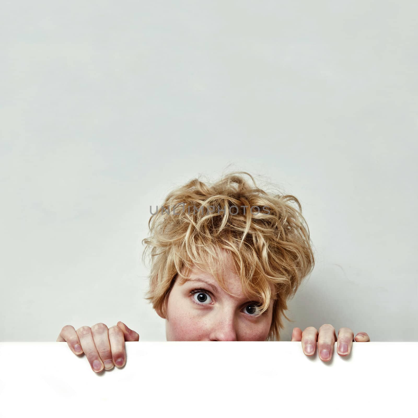 Young blond girl with morning look and mixed hairs on a white background