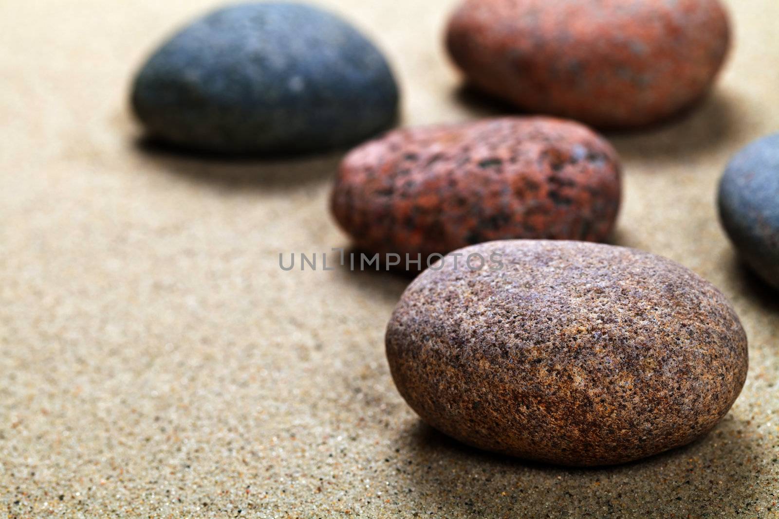 Pebble stones background with copy space. Sand beach texture. Macro shot
