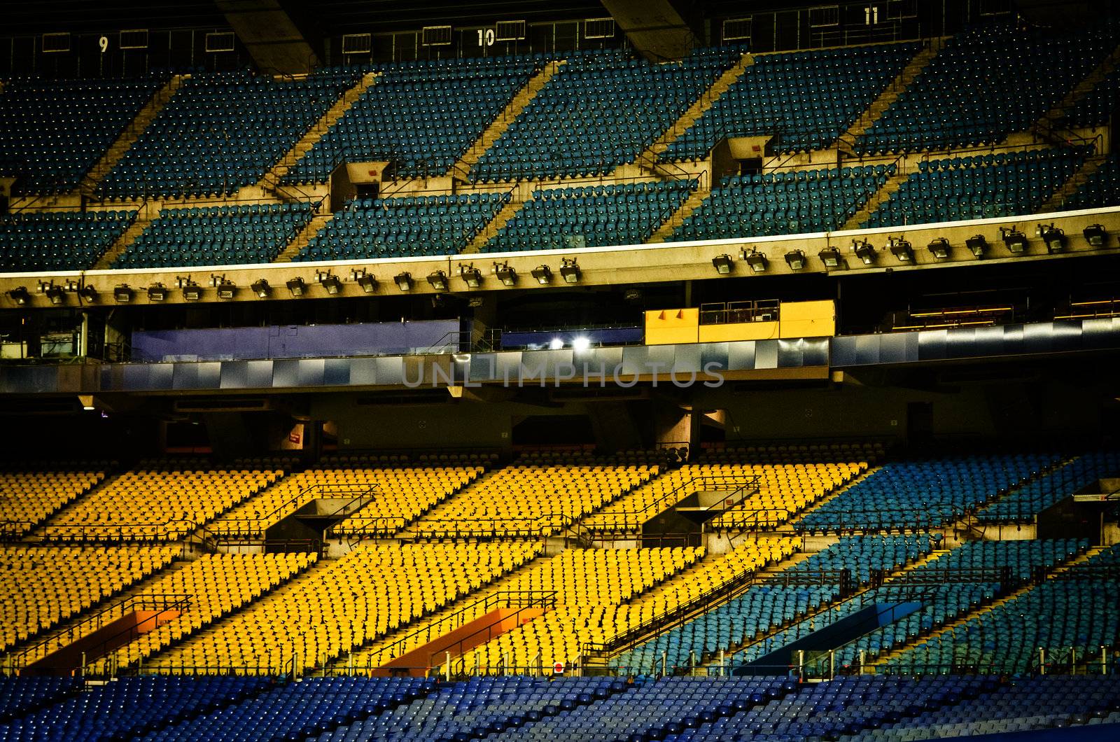 Abandoned and Empty Stadium with yellow and blue seats (nobody)