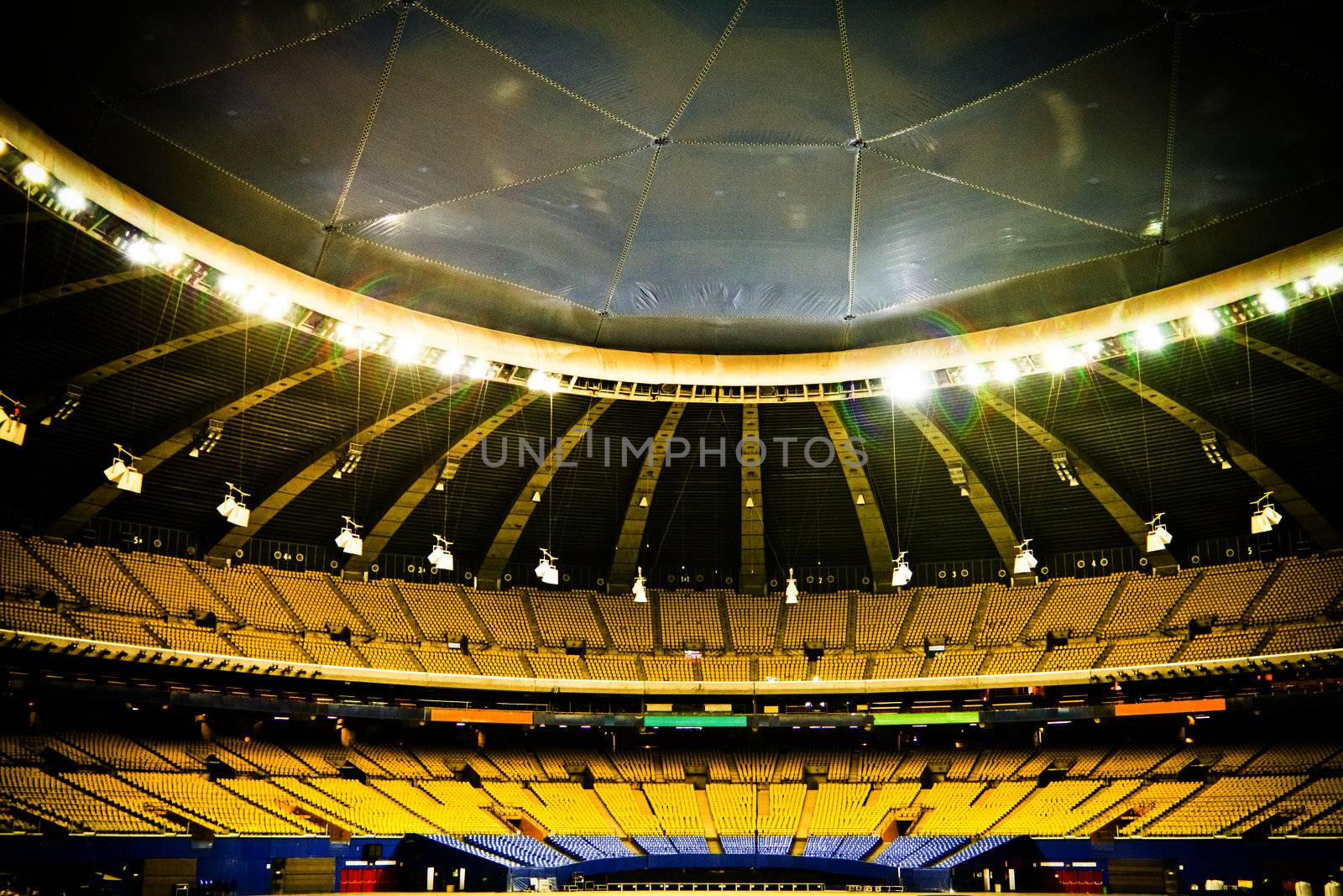 Abandoned and Empty Stadium with yellow and blue seats (nobody)