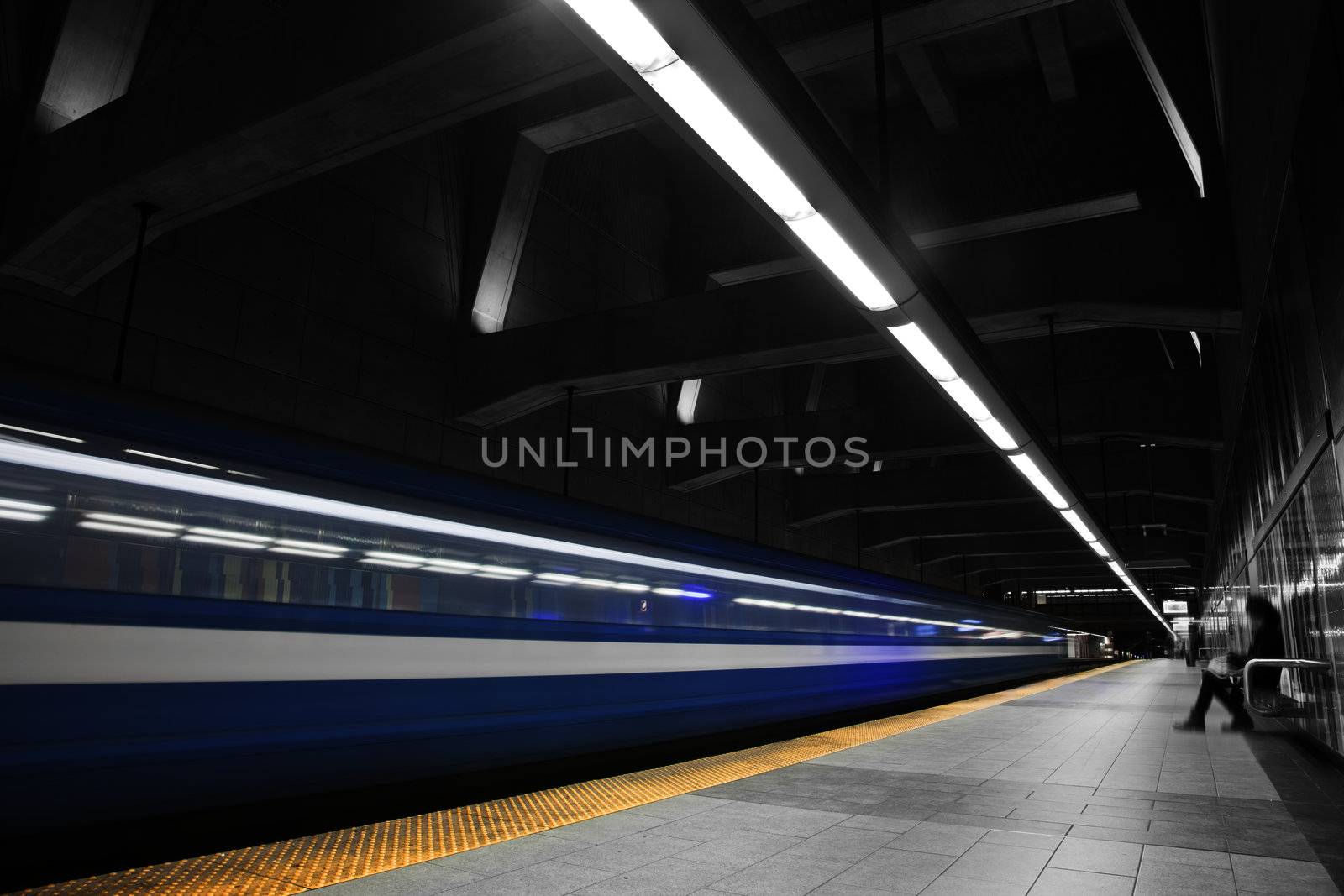 A Girl Waiting the metro to stop. A long exposure with a lot of movement.