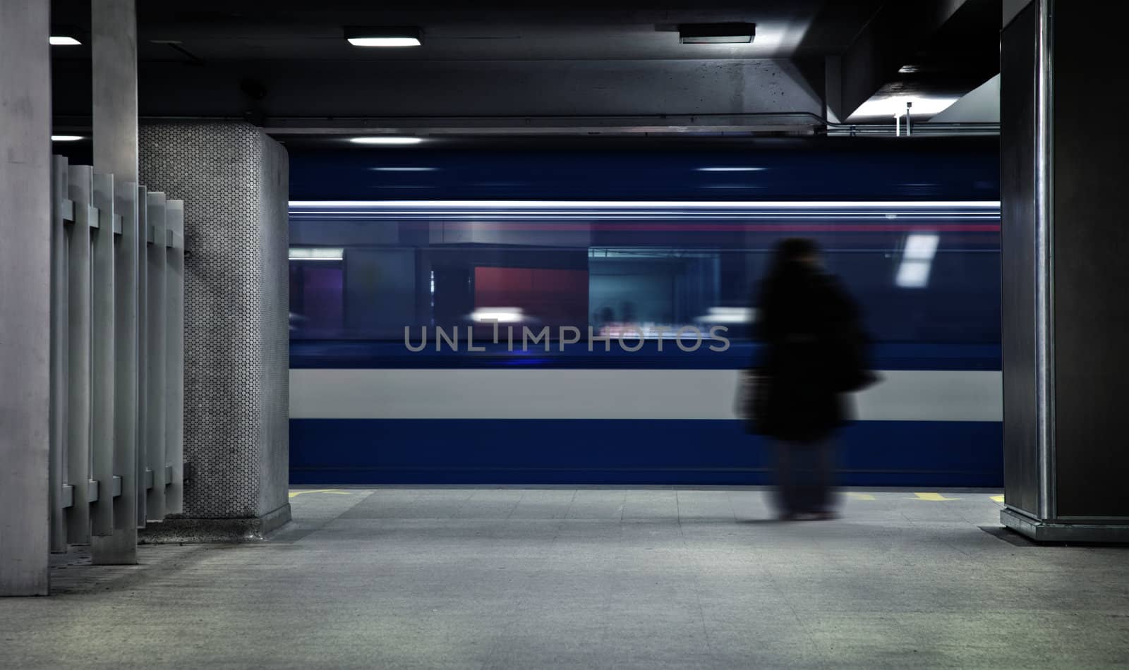 Someone waiting the metro. A long exposure of the wagon that show the movements and a blurry person just standing there.