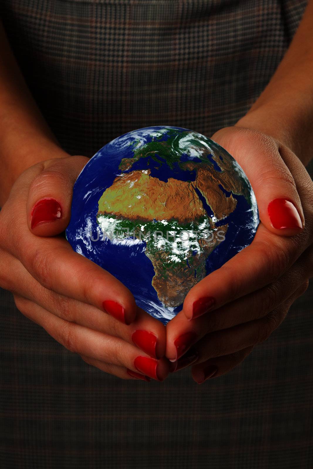 Women's hands holding the earth. Elements of this image furnished by NASA