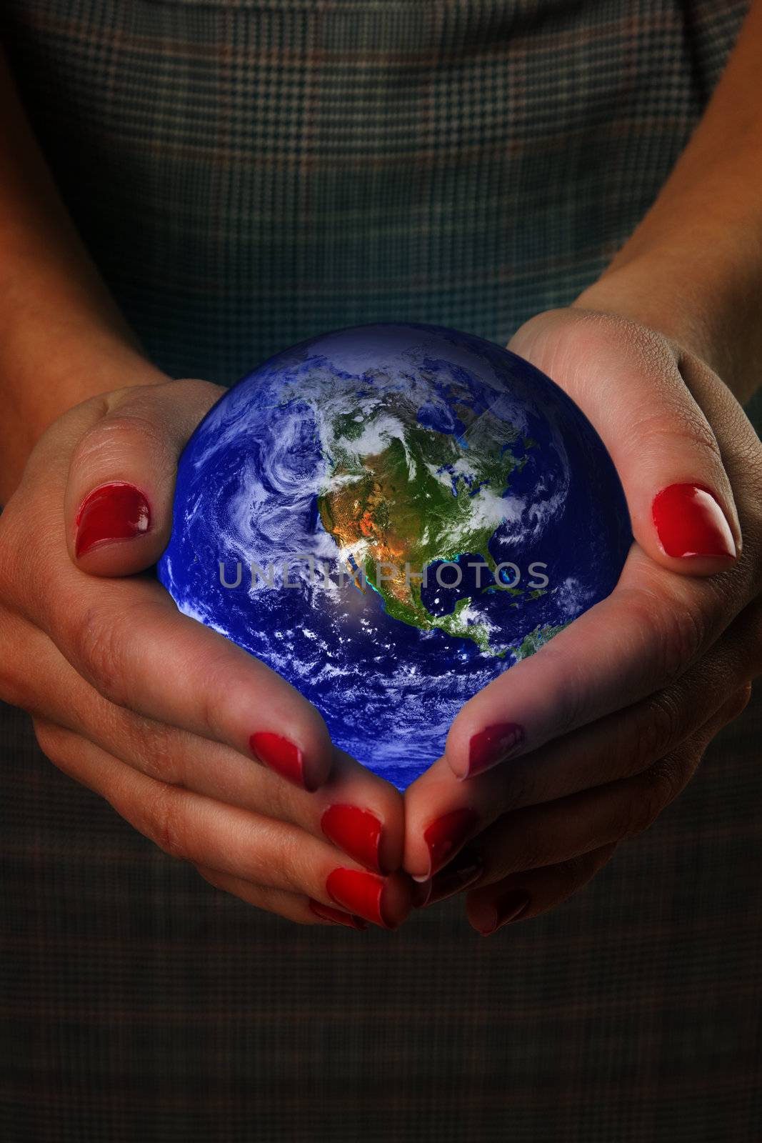 Women's hands holding the earth. Elements of this image furnished by NASA