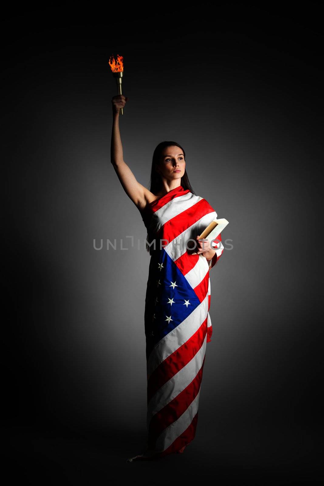 woman in the American flag in the style of the statue of liberty