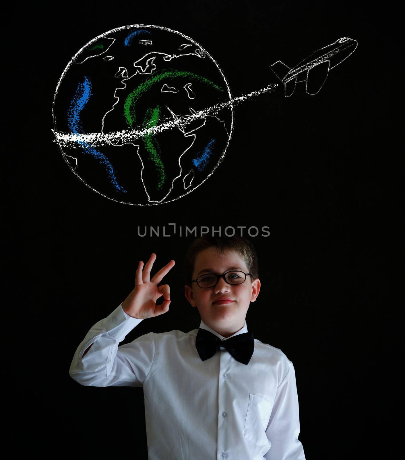 All ok boy dressed as business man with chalk globe and jet world travel on blackboard background by alistaircotton
