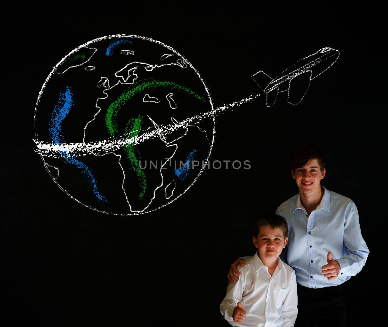 Thumbs up boy dressed up as business man with teacher man and chalk globe and jet world travel on blackboard background