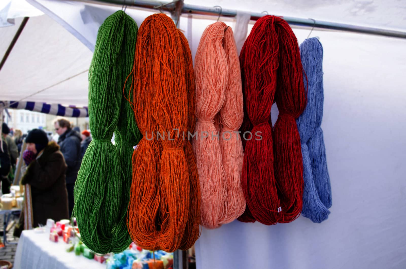 woollen wool colorful natural thread bunches hang sell in outdoor street market fair.