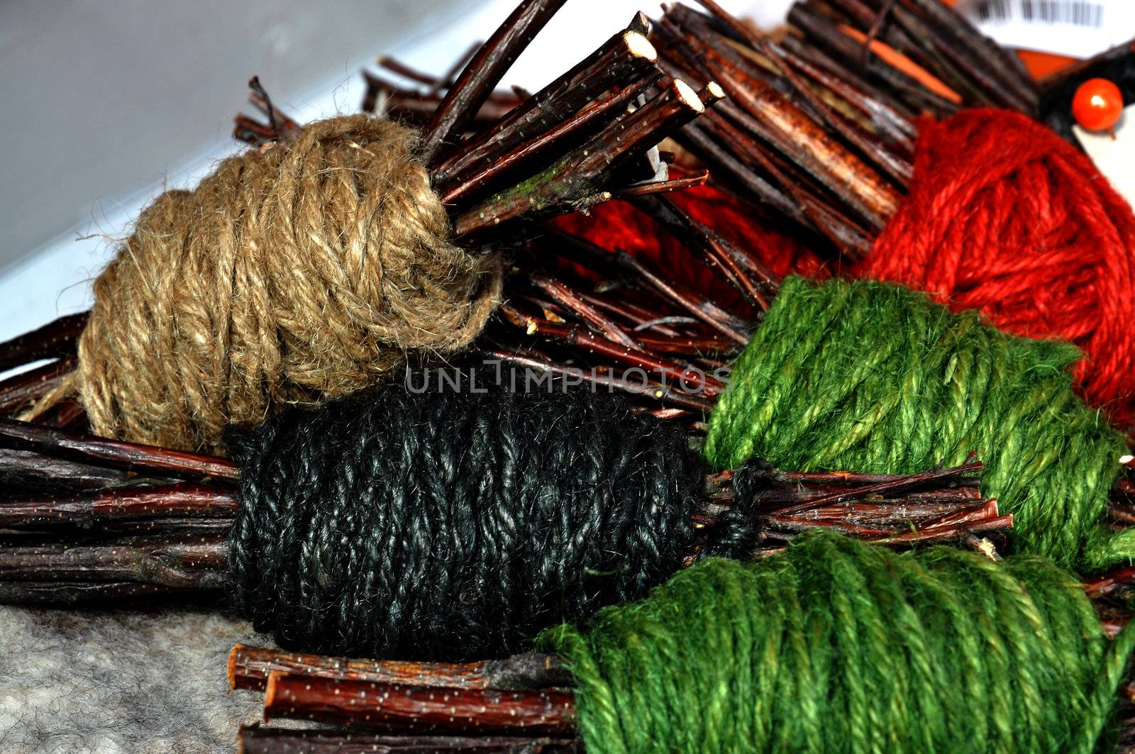 Handmade yarn skeins in a bundle with twigs as a part of interior decoration.
