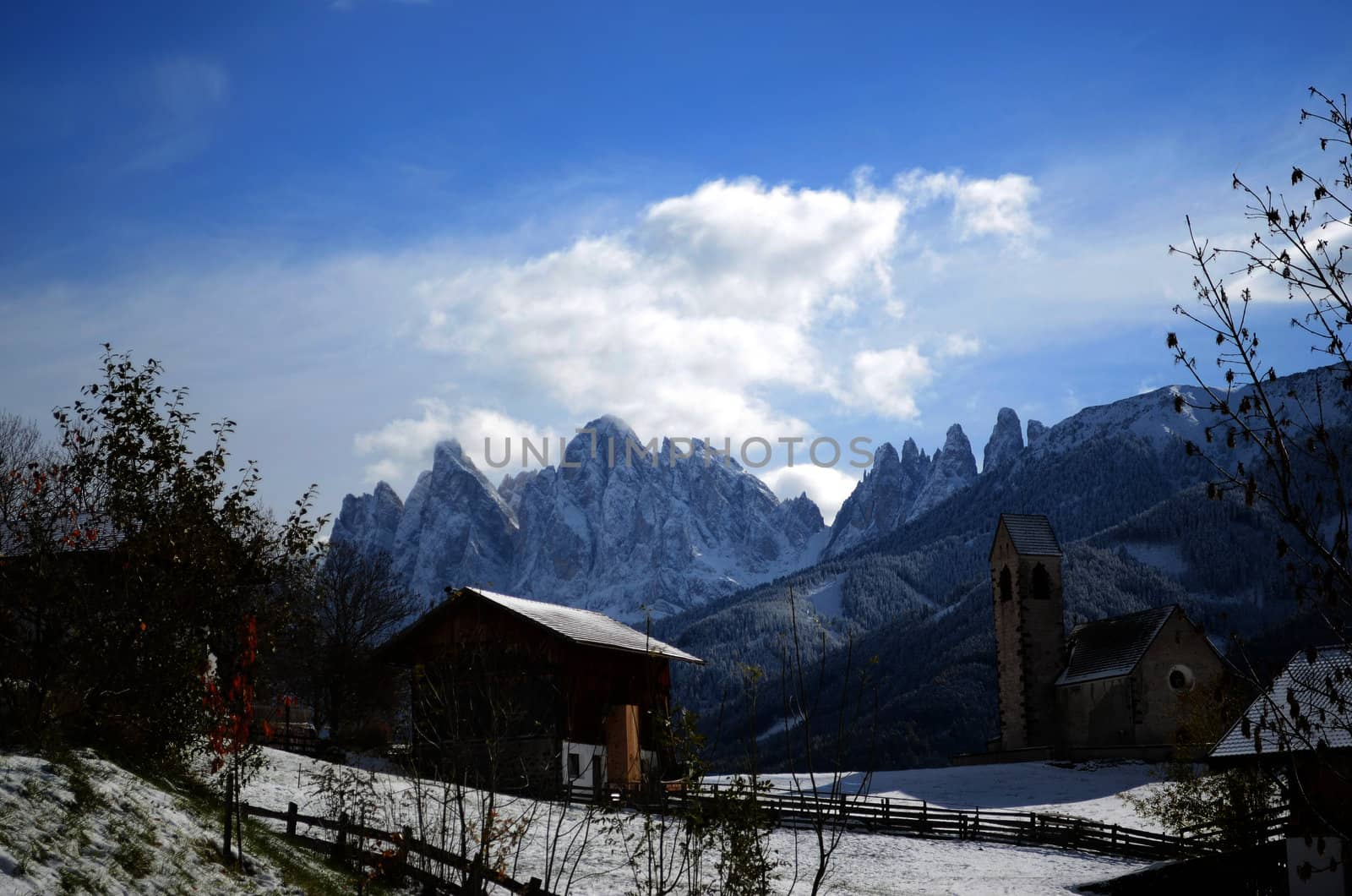 The mountain village and church of St. Jakob (San Giacomo) near St. Magdalena (Santa Maddalena) in the Villnosstal (Val di Funes) in South Tyrol in Italy in winter with in the background the Geisler (Odle) dolomites group.