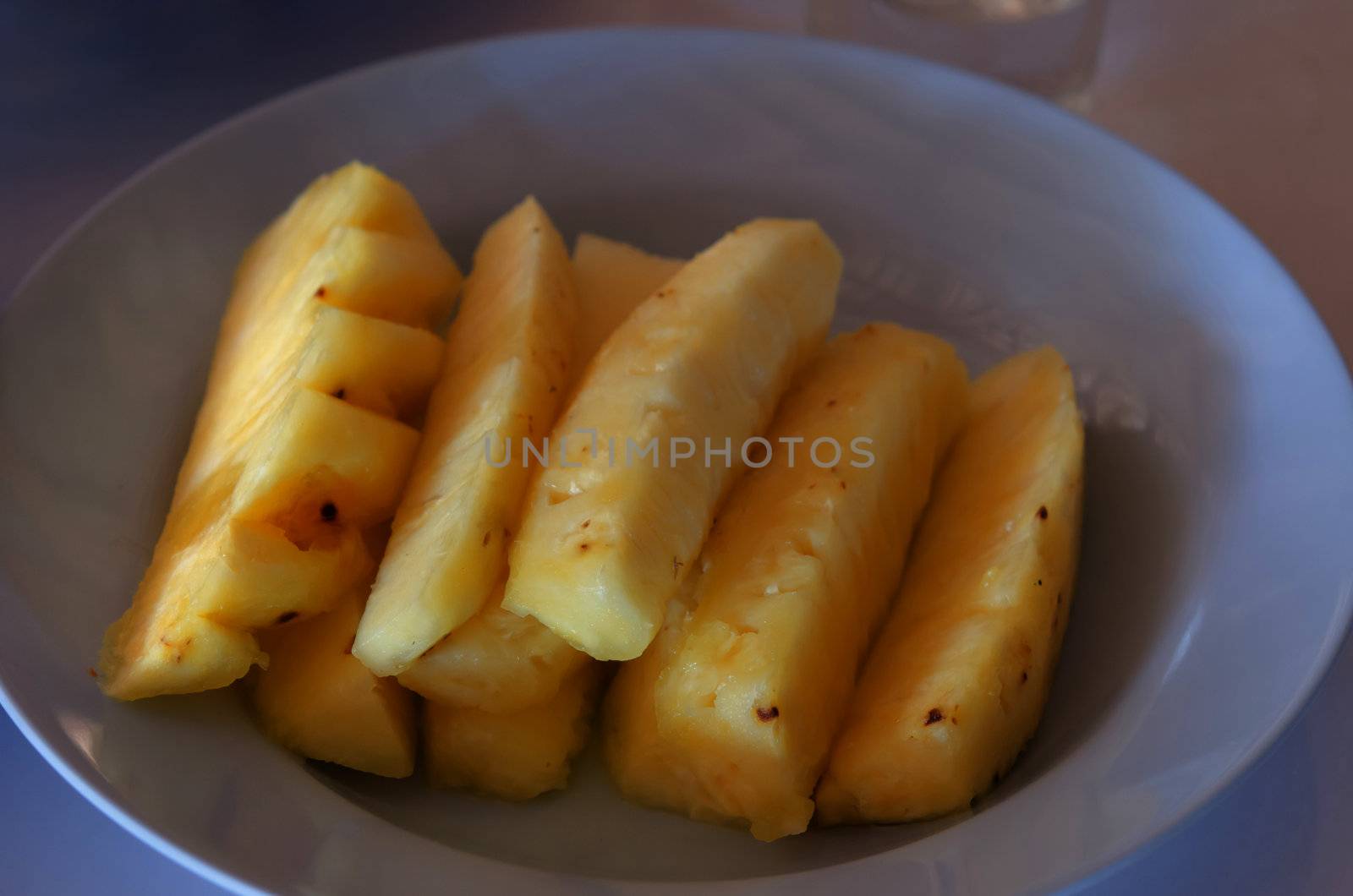 close up fresh pineapple pieces on dish