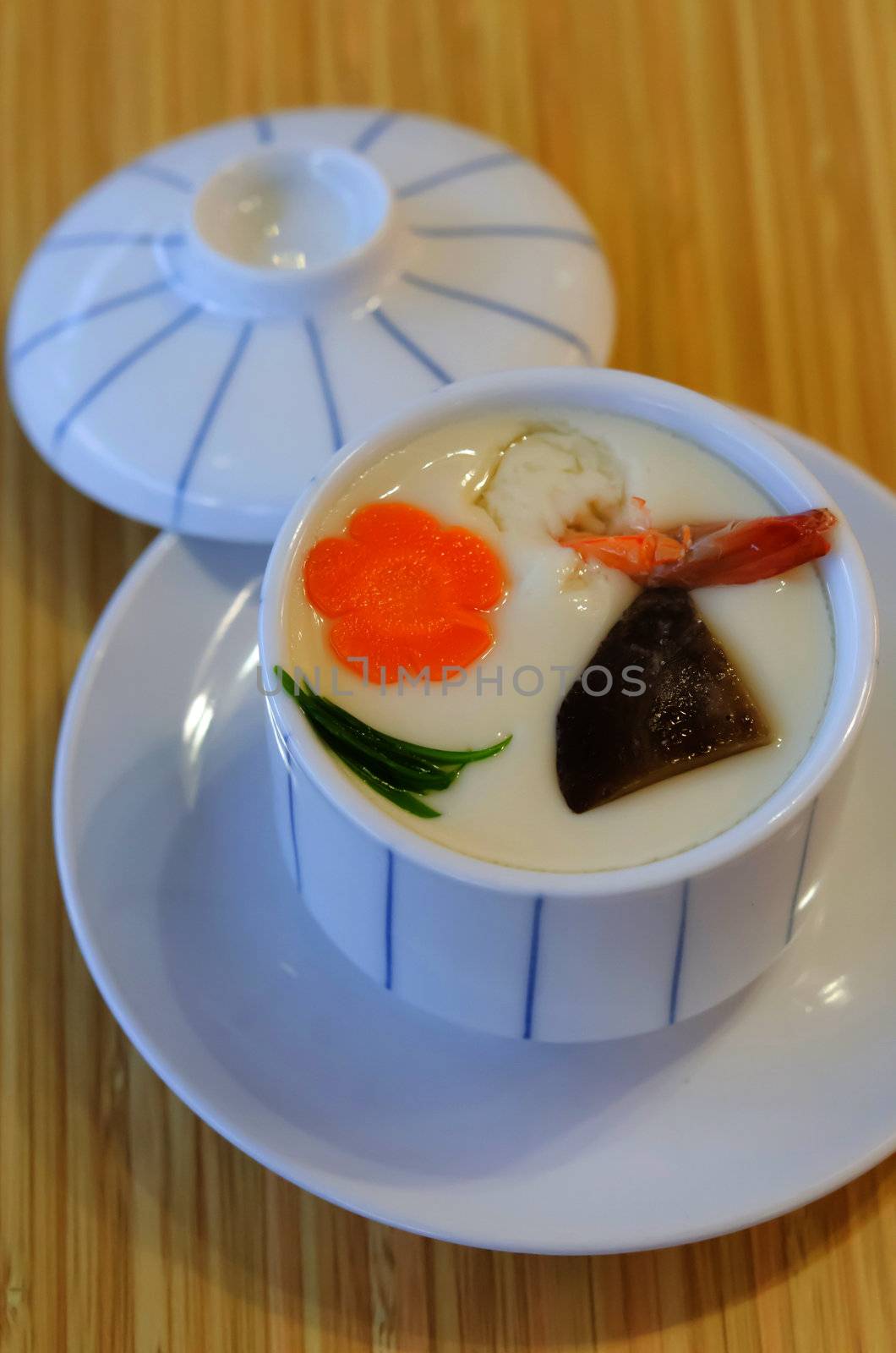 steam egg with meat  and vegetable in white bowl on wooden background