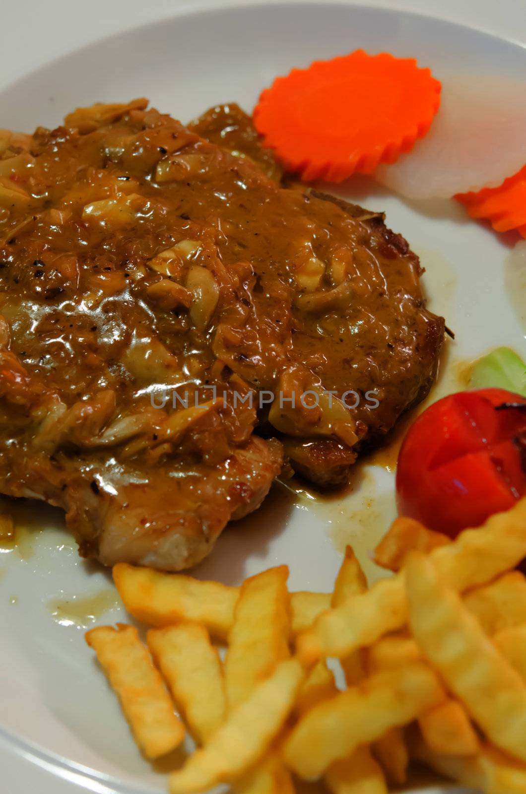 beef steak with vegetable , tomato and  french fries