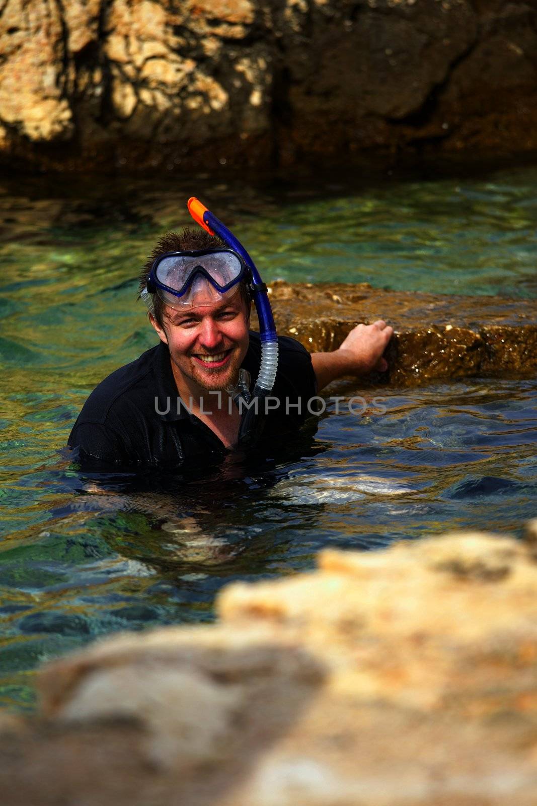 Young man snorkeling happily in the sea