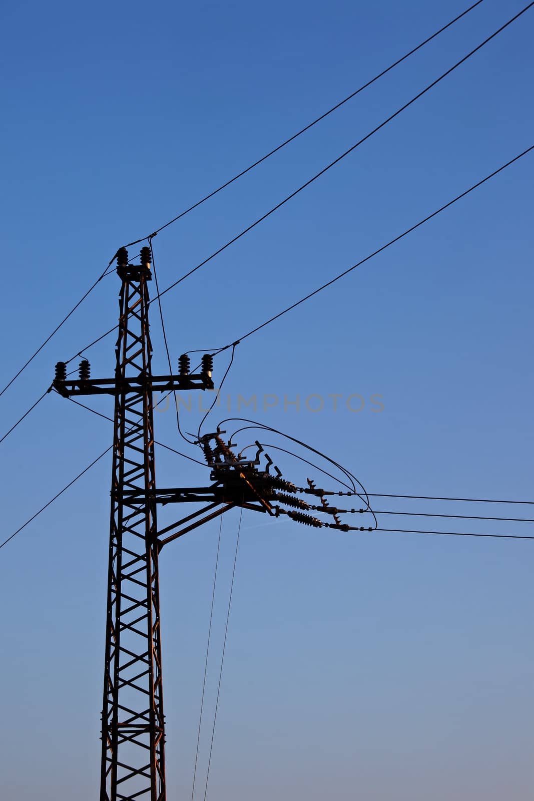 Electric line against clear blue sky
