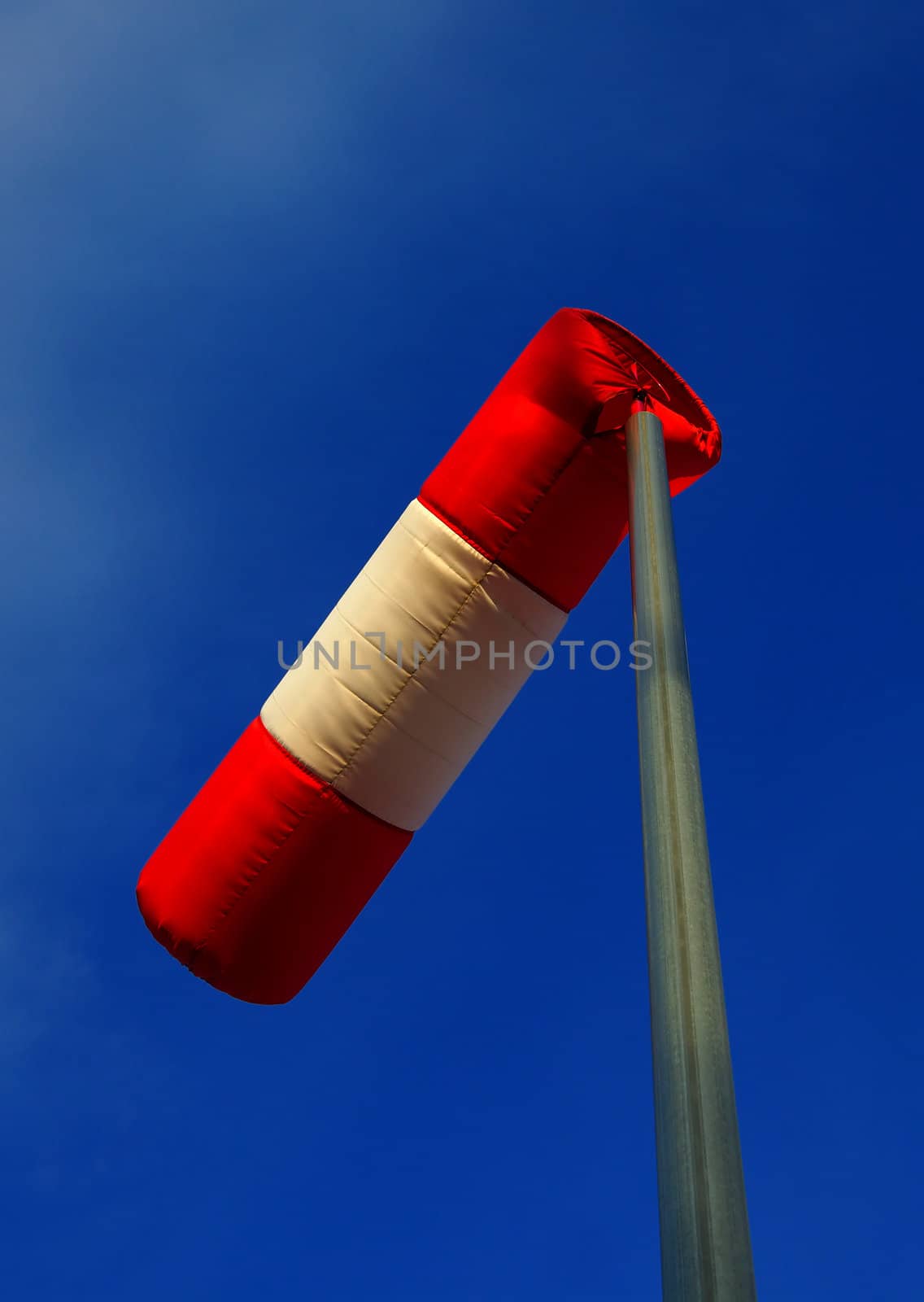 Windsock against clear blue sky