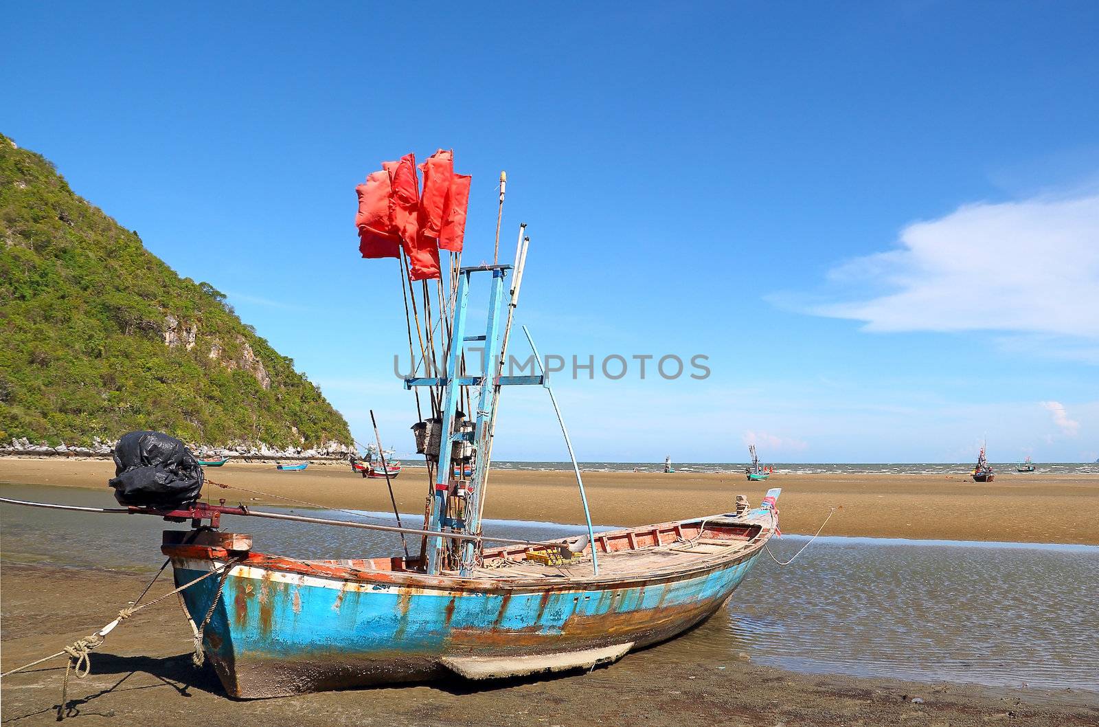 Fishing boat on the beach in front of the Pranburi sea in Thailand