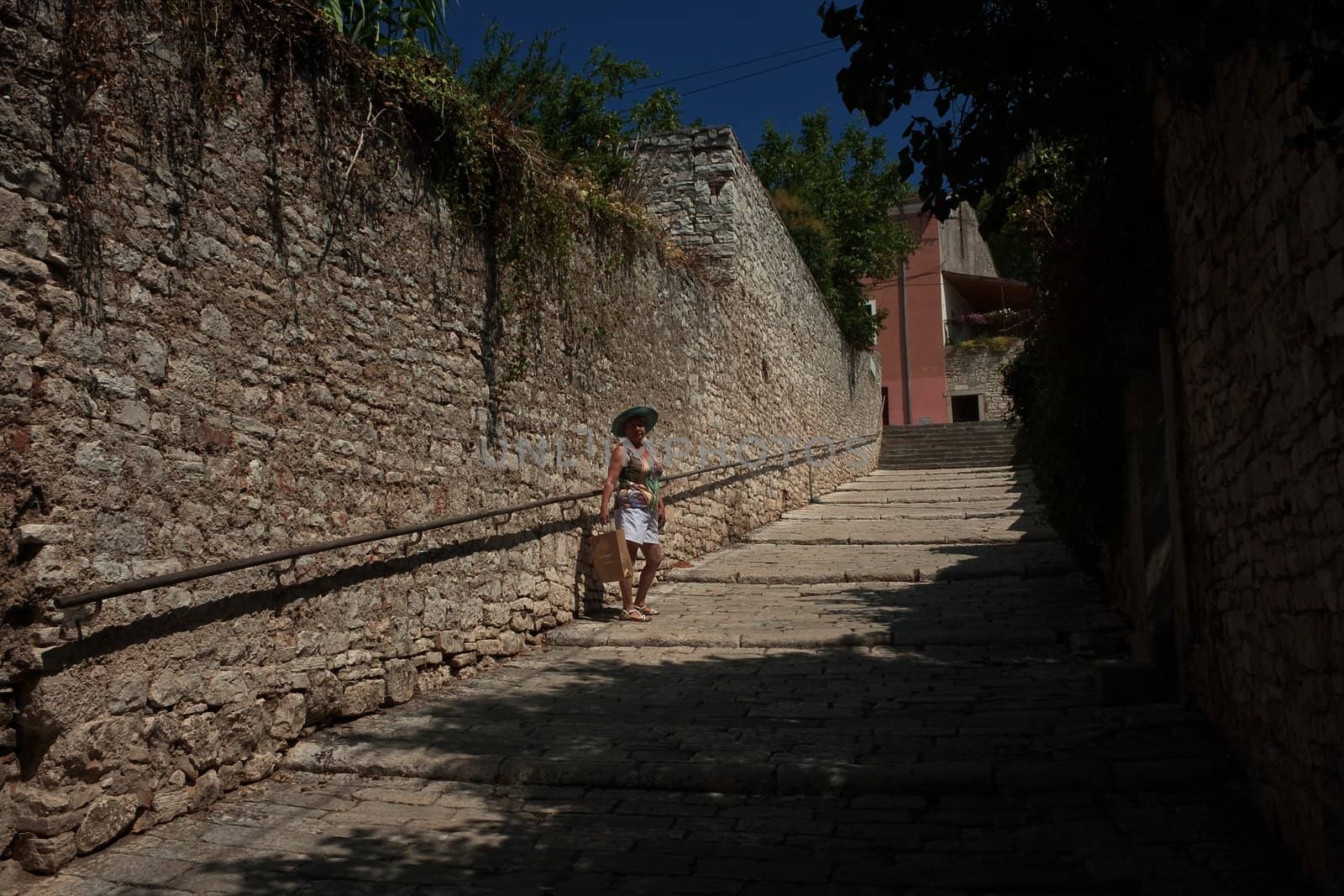 A tourist on the streets of the historic center of Pula, Croatia