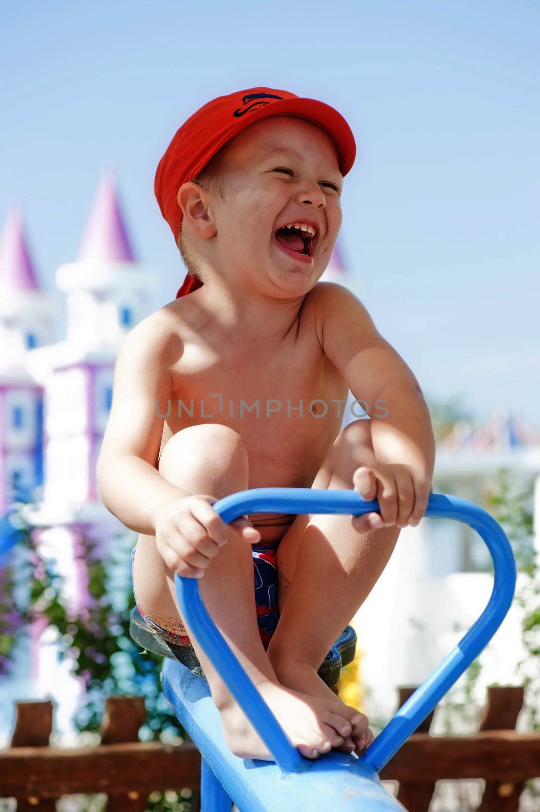 Happy child swinging on a swing by kosmsos111