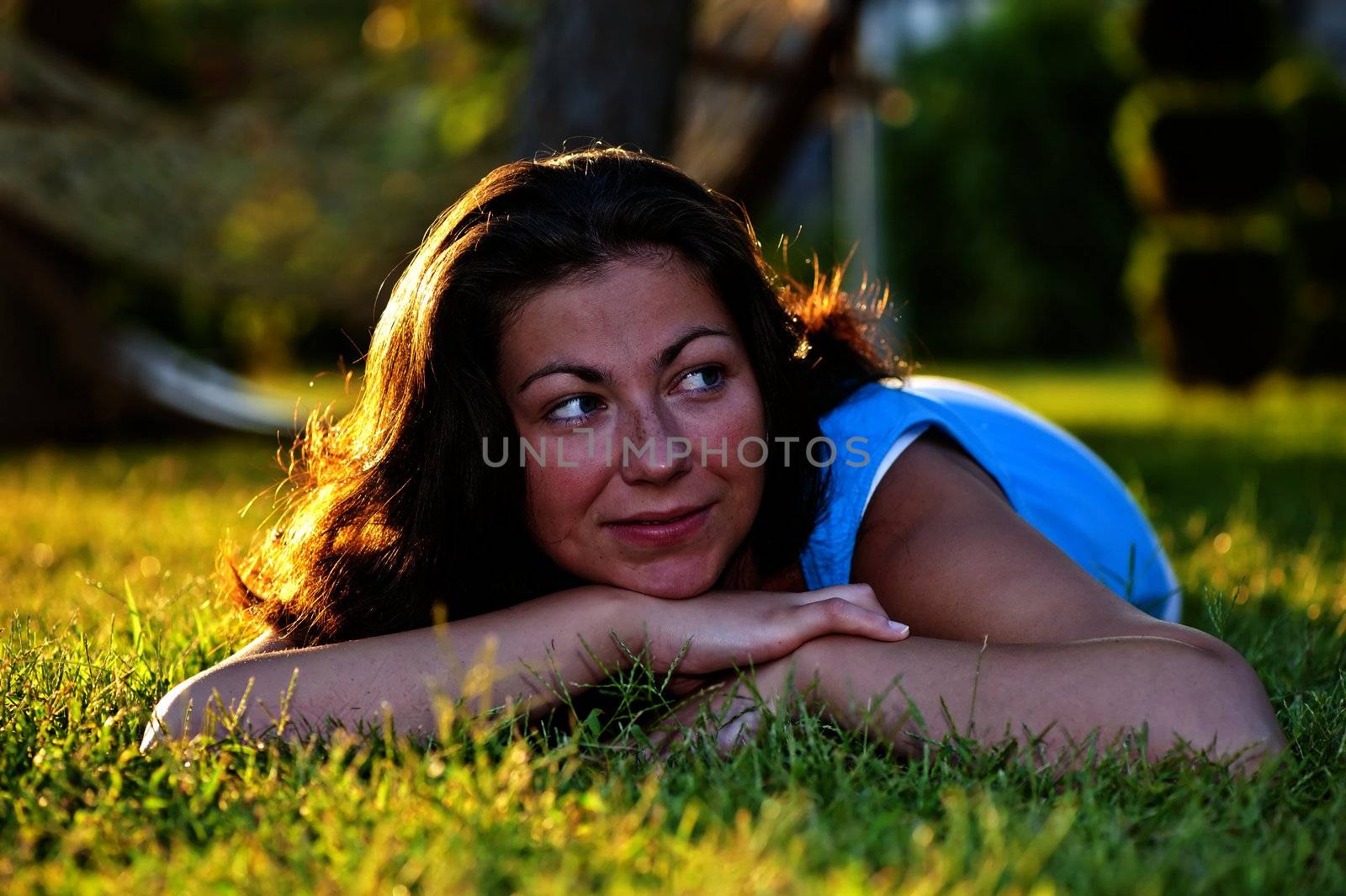 Brunette girl lying on the grass