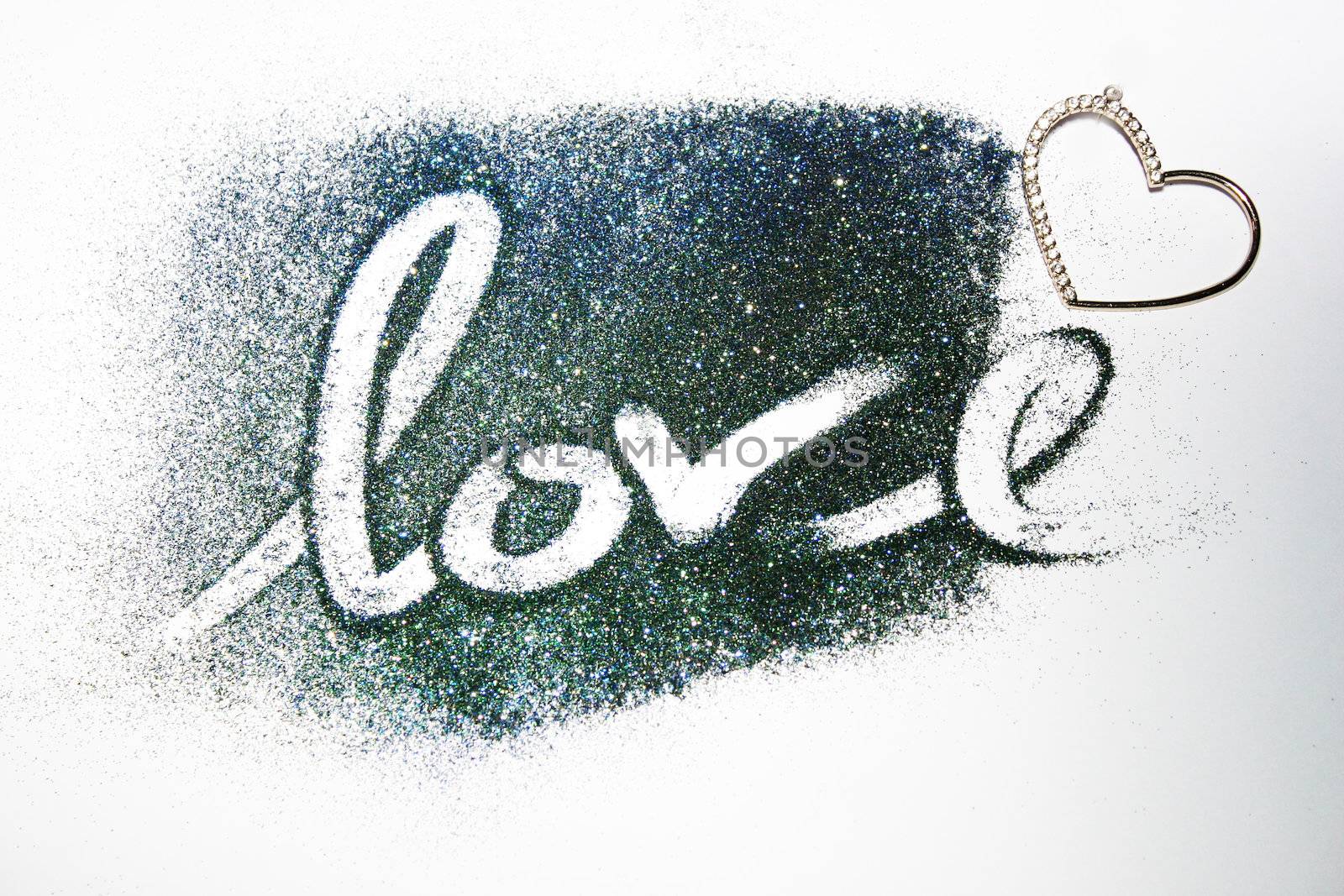 The word love written on colored glitter powder by valentinacarpin