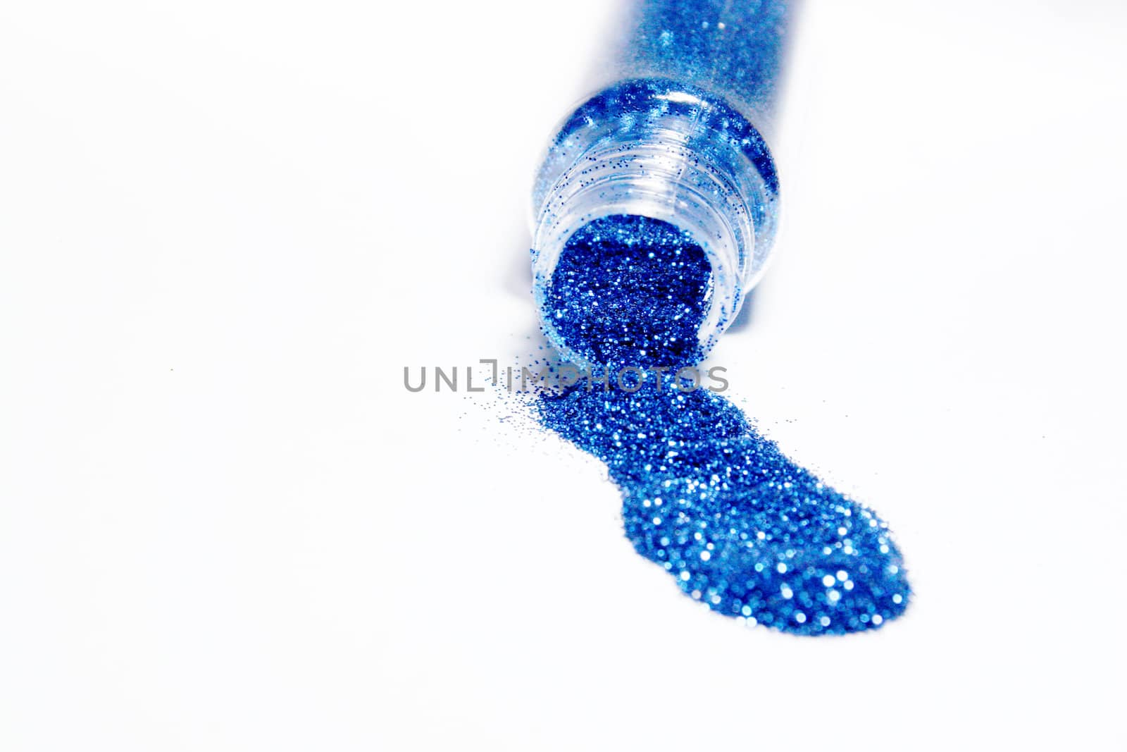 Blue glitter powder coming out from a bottle
