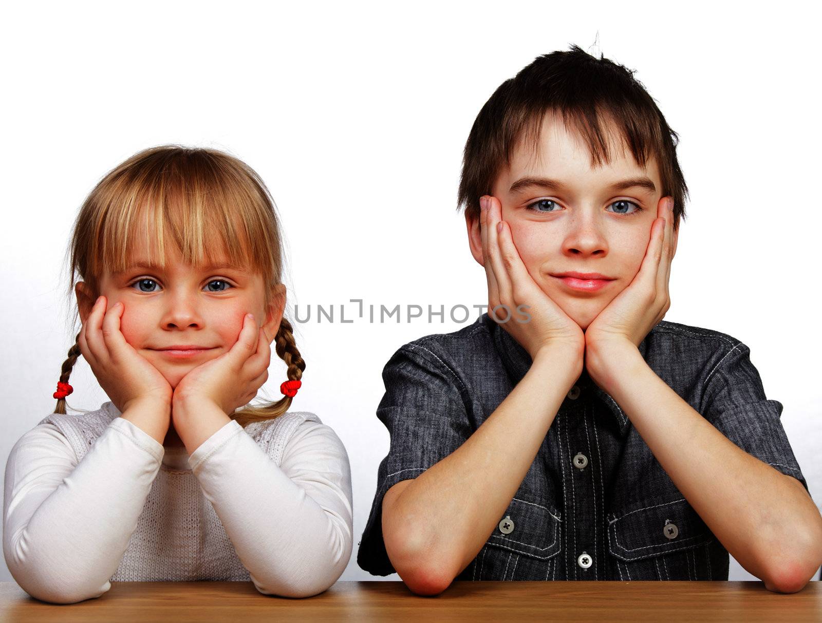 Sister and brother sitting at desk by naumoid