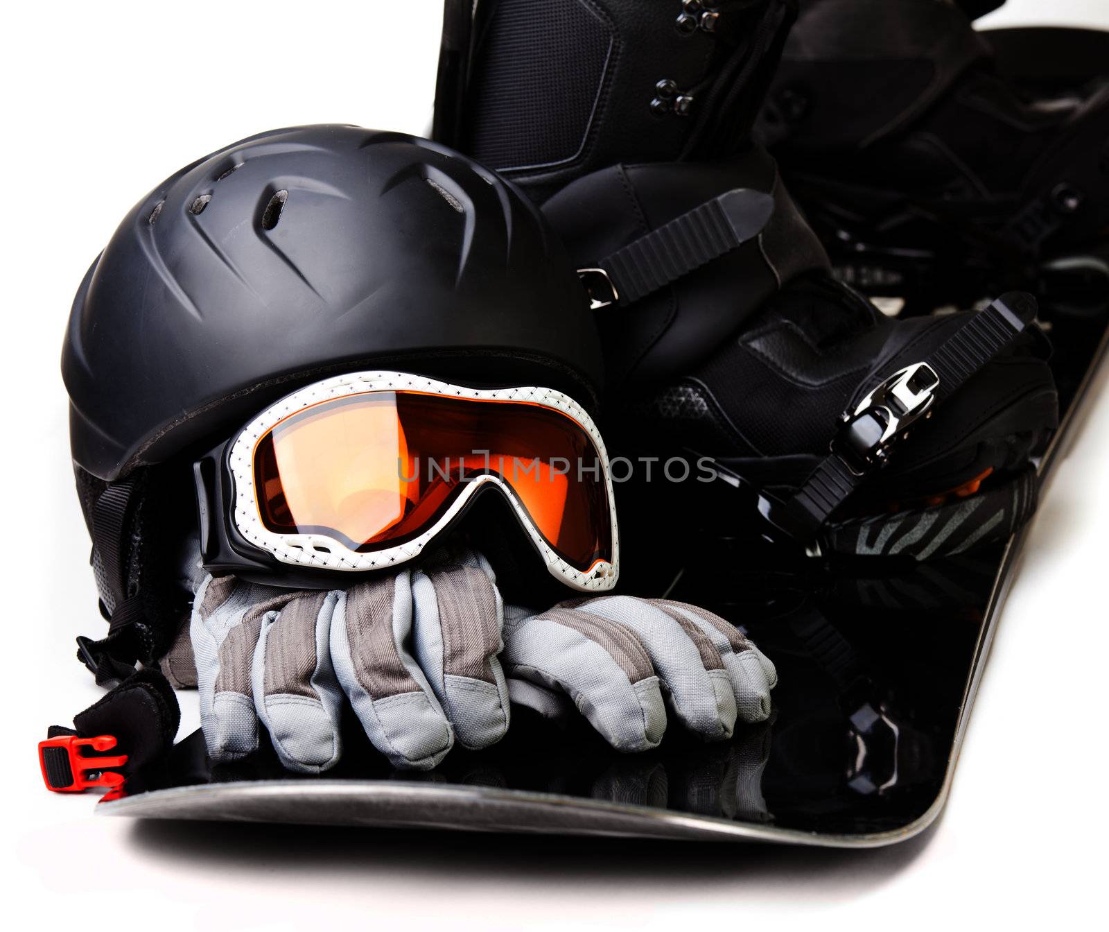 Snowboard with boot helmet gloves and goggles on white background
