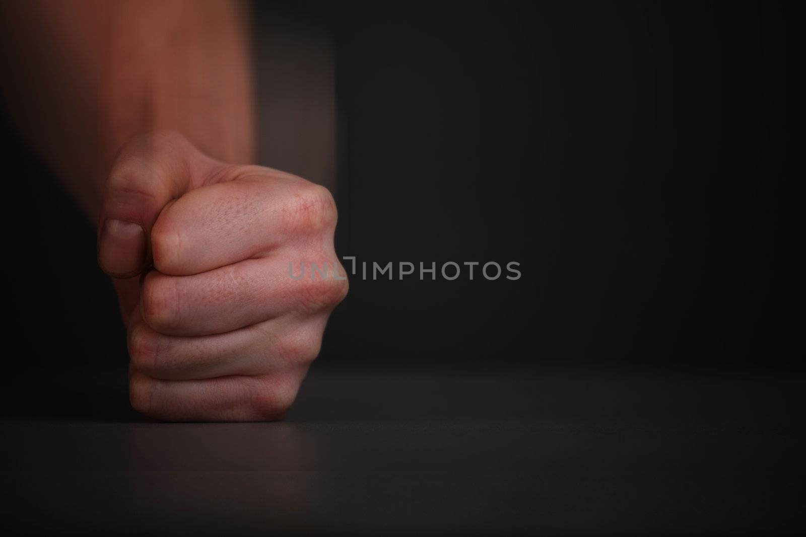 Man fist hit with a sweep of the table.