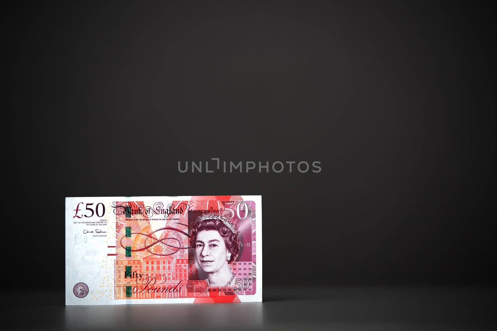 The Fifty pounds sterling. On a gray background