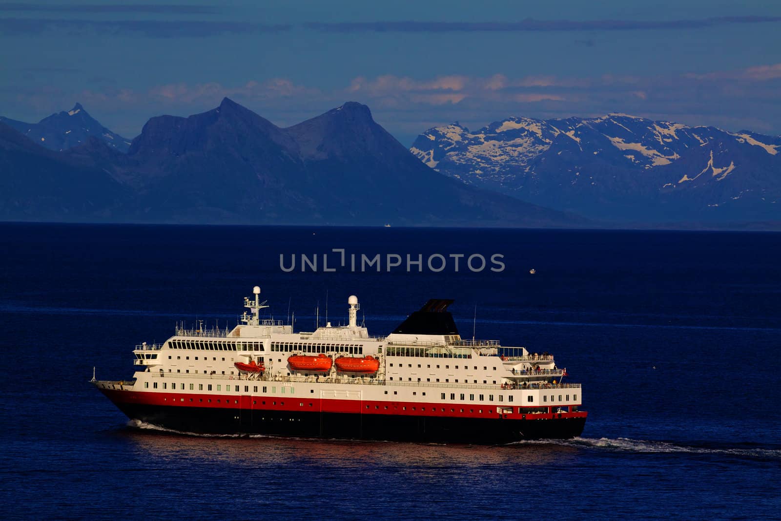 Passenger ship cruising along norwegian coast near Lofoten islands