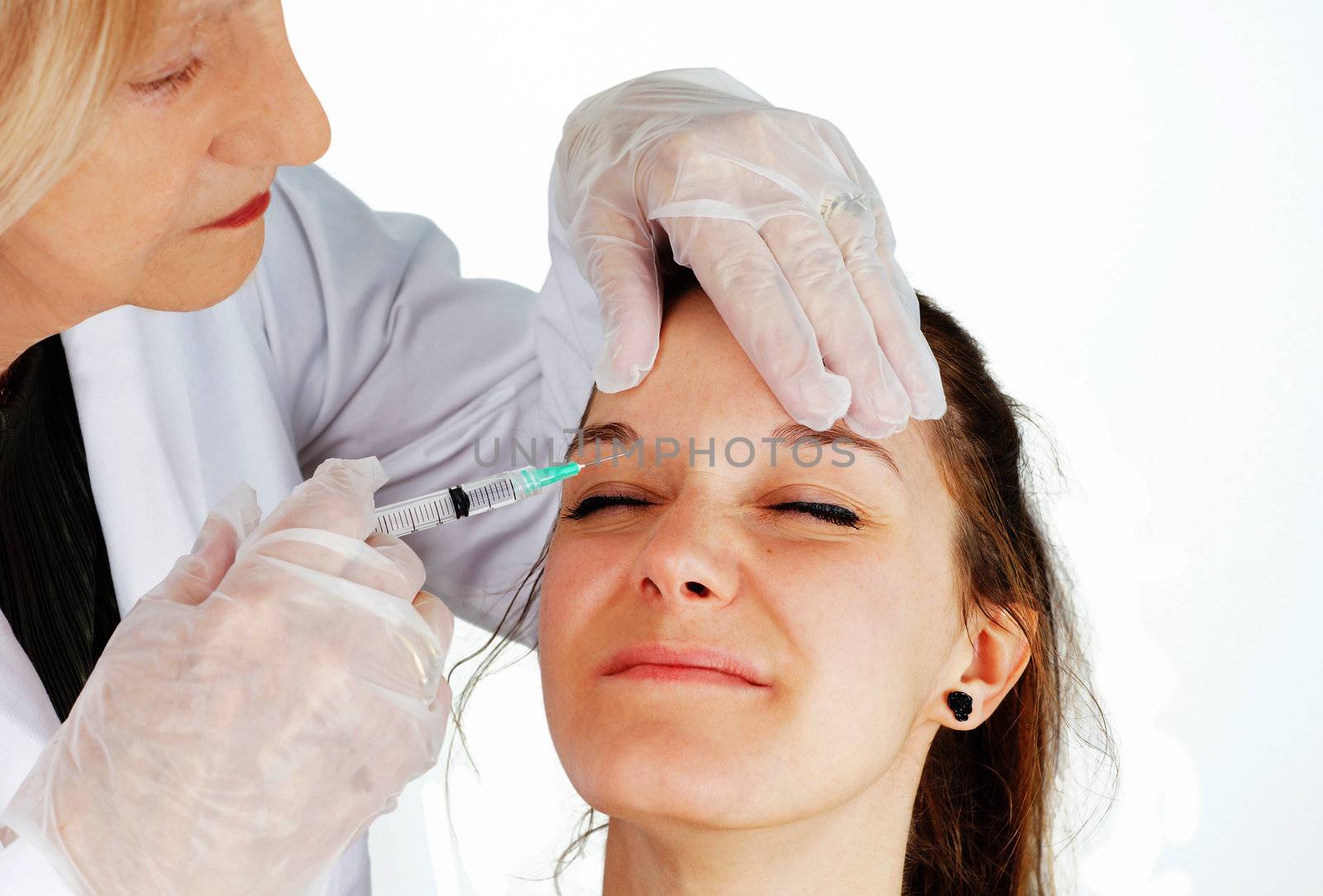 Young woman getting botox in her frown by Mirage3