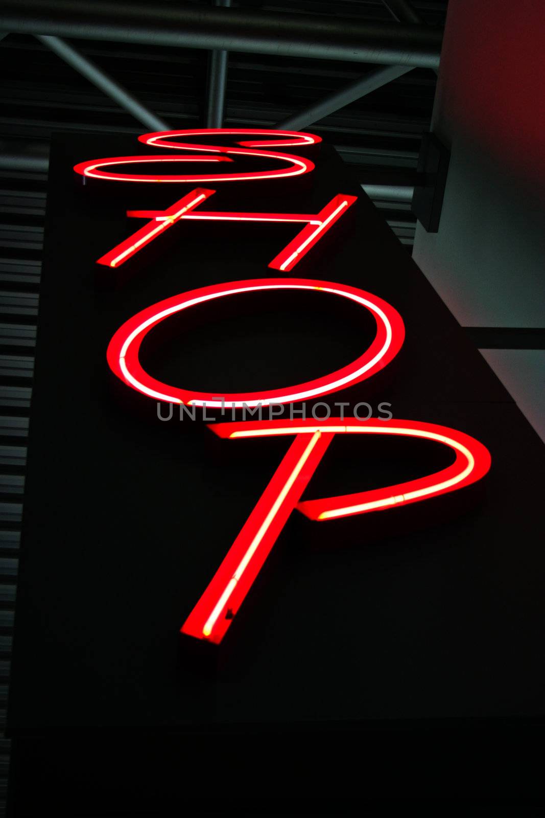 Red neon light as advertisement for a Shop