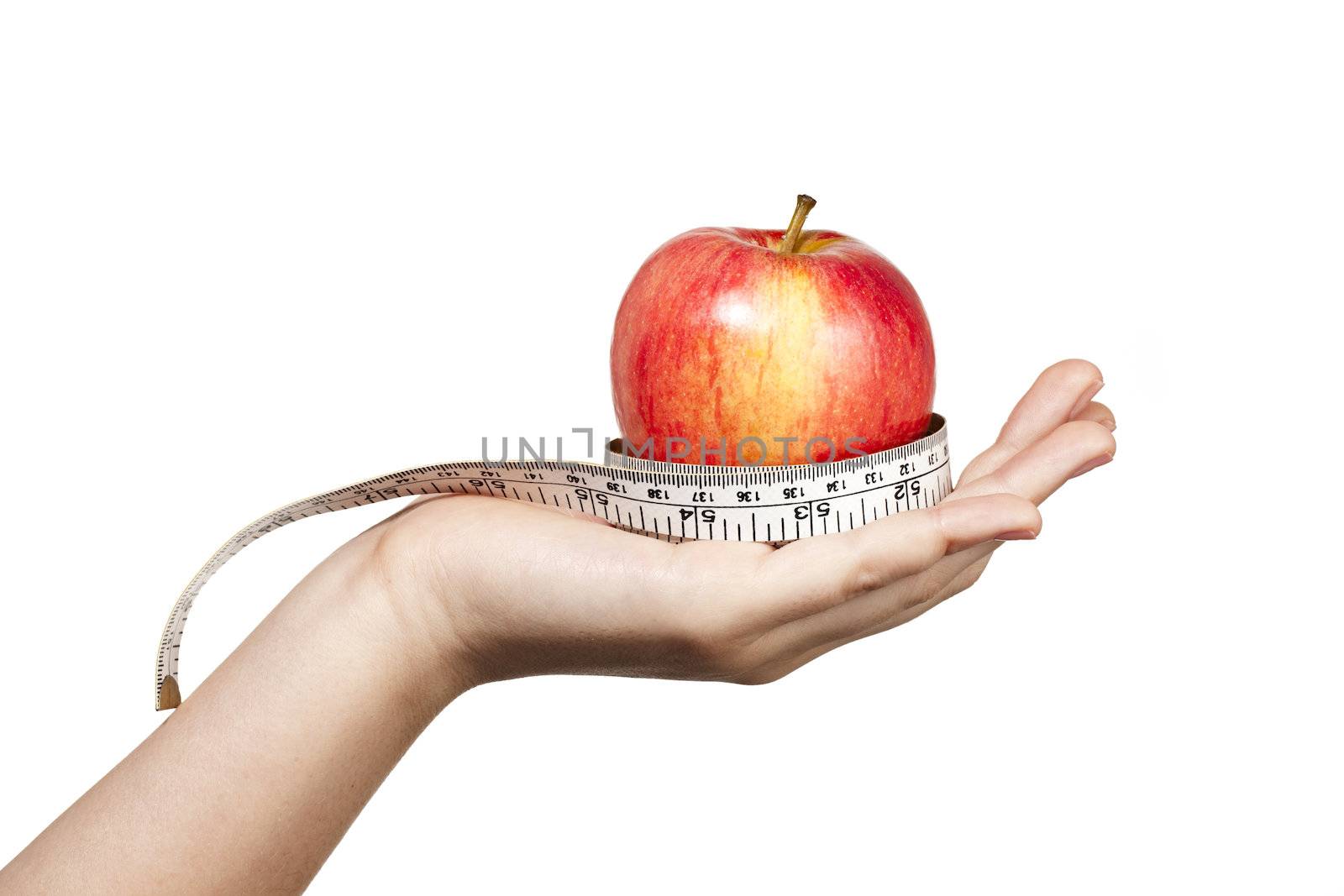 Hand extened with an apple resting and wrapped in a flexible tape measure.