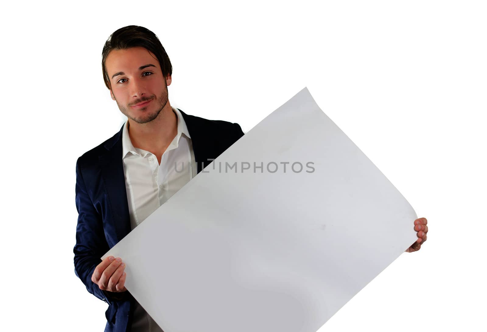 Attractive young man holding and showing empty, blank white board, sign or paper sheet